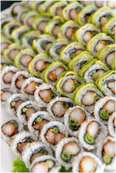A close-up of assorted sushi rolls with vibrant ve