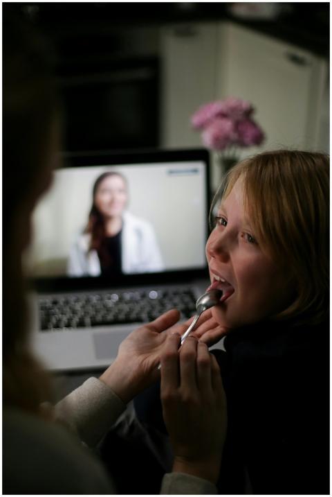 Young child receiving remote medical advice via te