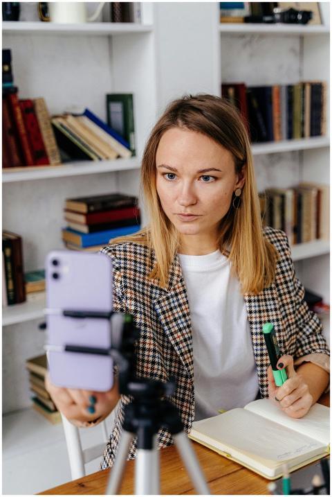 A focused woman conducting a video call in a styli