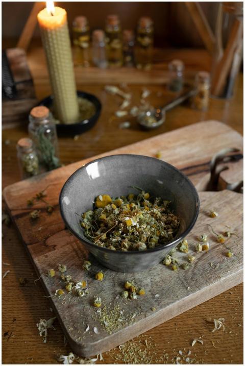 Rustic wooden scene with dried herbs in a ceramic