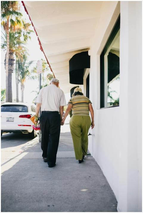 Senior couple holding hands walking together outdo