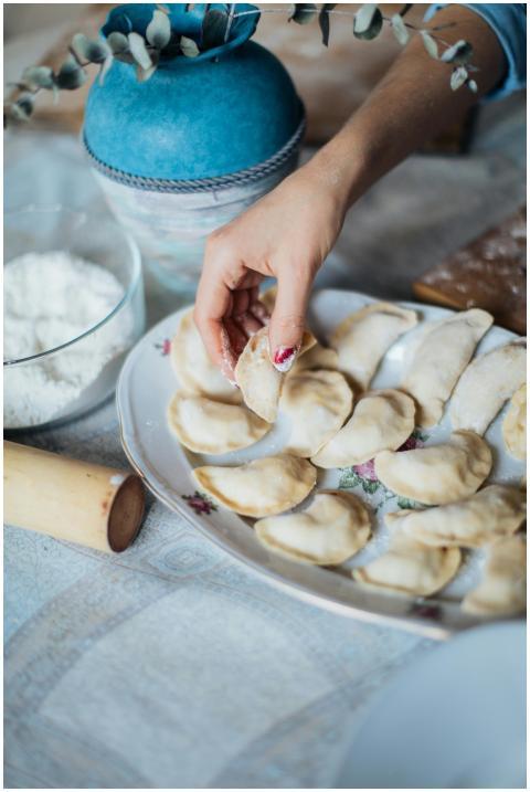 A close-up of a woman's hands making traditional p
