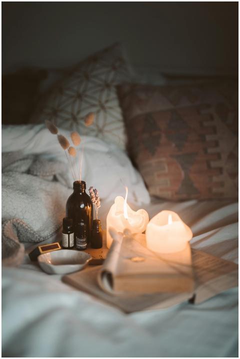 A warm and cozy bedroom scene with burning candles