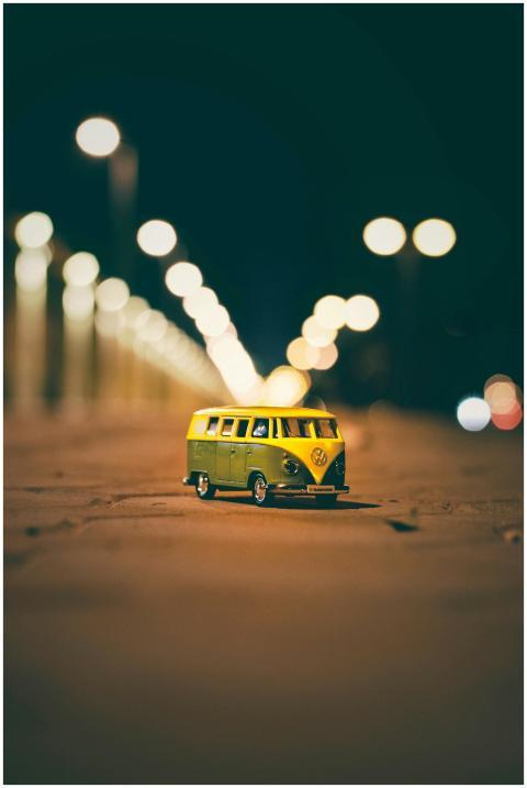 A colorful toy van captured at night with streetli