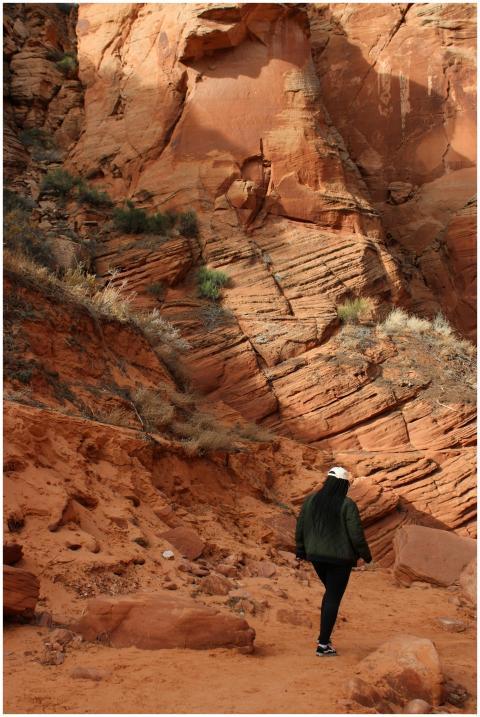 A person walks through the stunning red rock forma