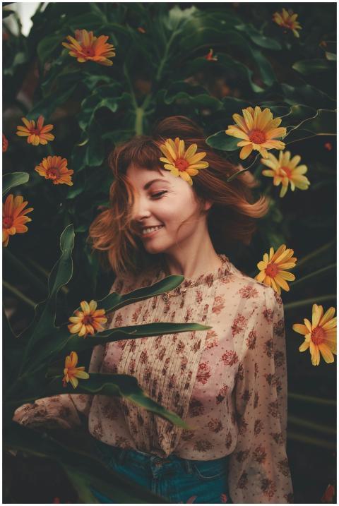 A young woman in a floral dress smiles among vibra