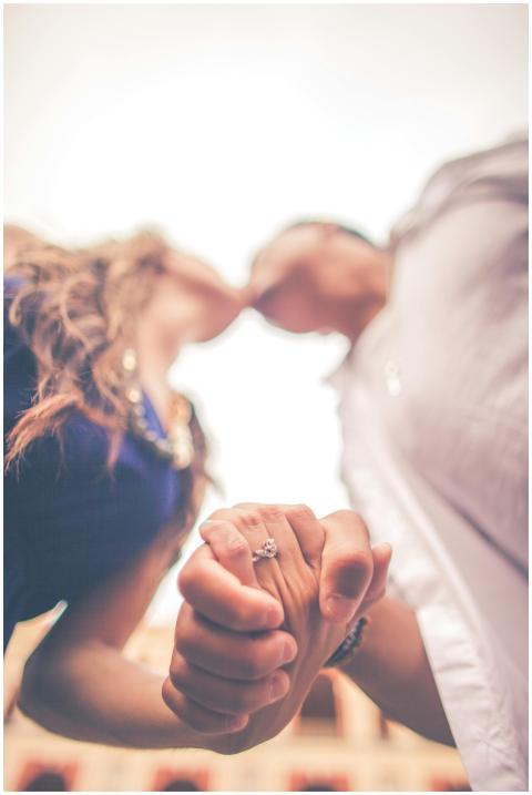 Romantic couple holding hands and kissing, focusin