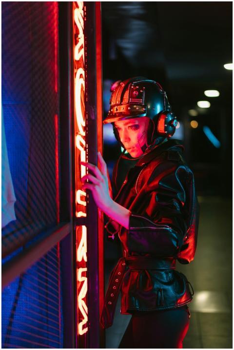 Woman in a cyberpunk helmet and jacket with vibran