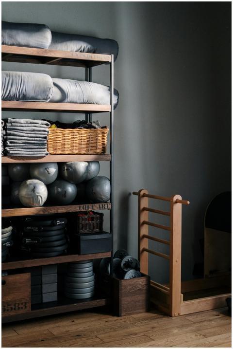 Neat arrangement of gym equipment and yoga mats in
