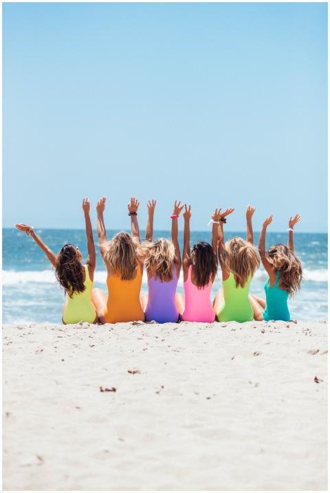 A joyful group of women with hands raised enjoying