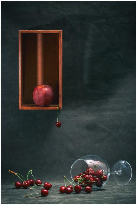 Artistic still life of apples and cherries with a