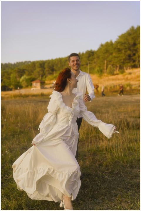 Happy couple dancing in a meadow, capturing a warm