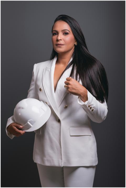 Professional female engineer holding hard hat, exu