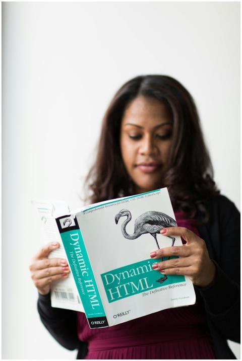 A woman focused on reading a book about Dynamic HT