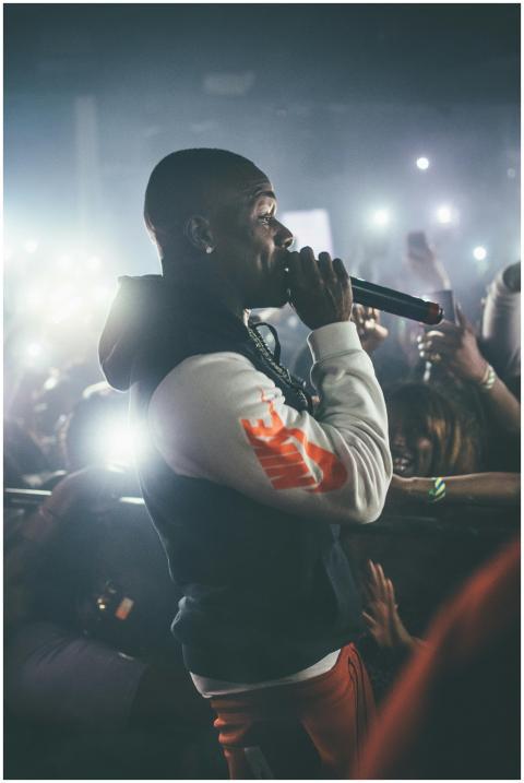 Dynamic shot of a rapper performing live in a crow