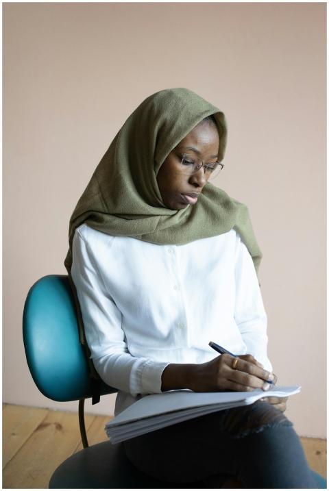 Serious young African American Muslim female weari