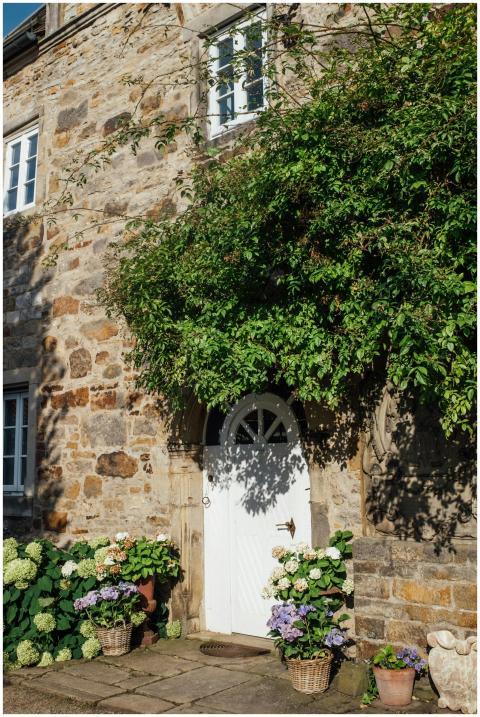 Rustic stone house facade adorned with vibrant pla