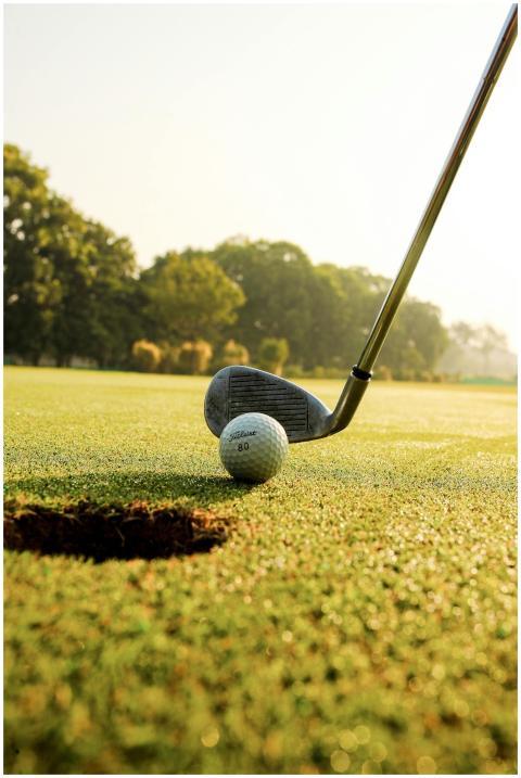 Closeup of golf ball placed on green grassy court