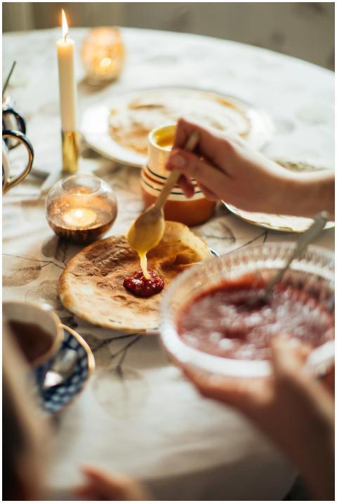 A cozy indoor setting showing crepes with jam, hig