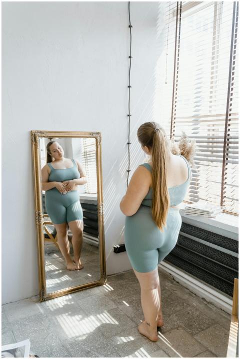 Confident plus size woman in activewear looking at