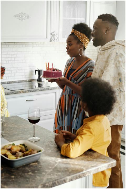 A joyful family gathering around a birthday cake i