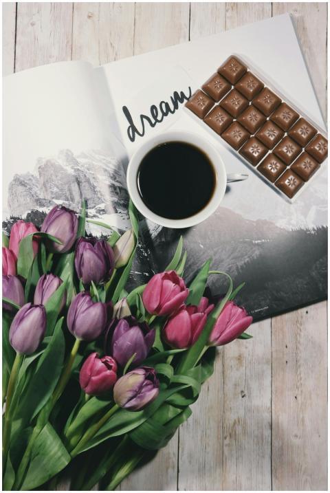 A warm setup featuring a cup of black coffee, colo