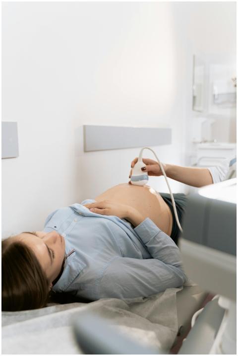 Pregnant woman receiving ultrasound scan in clinic