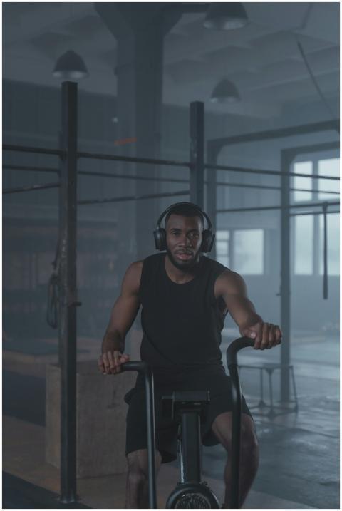 Man working out on a stationary bike in a gym, foc