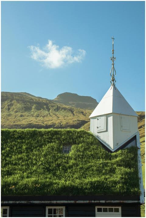 Charming church with grass roof set against a moun
