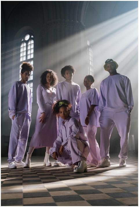 Fashionable group poses in lavender attire inside