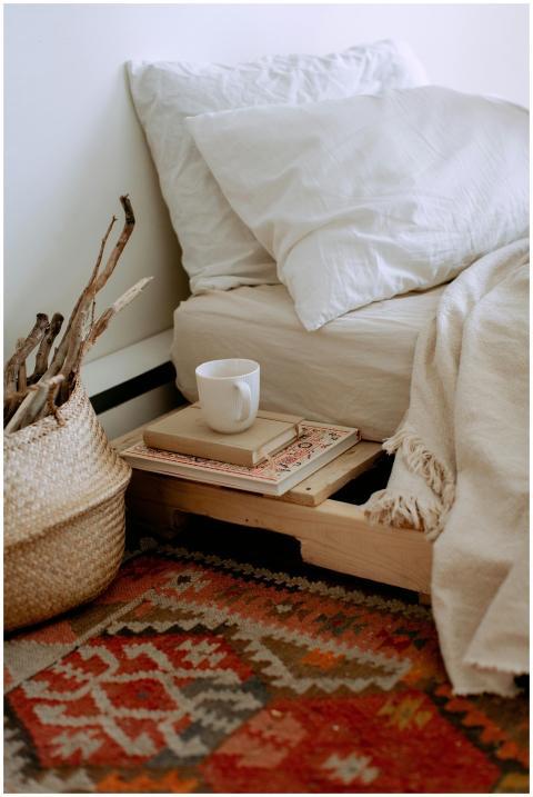 Comfortable cozy bedroom with bed wooden shelves w