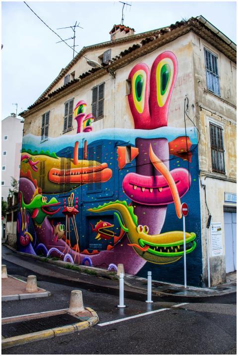 Colorful street art mural featuring monsters on a