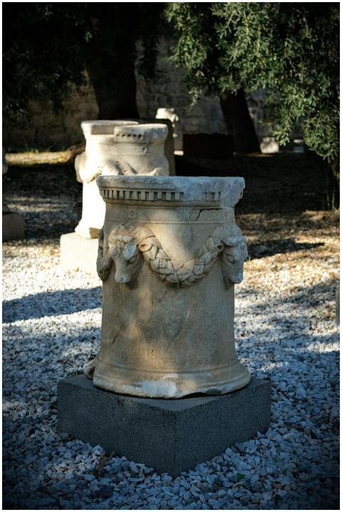 An ancient marble sculpture displayed in an outdoo