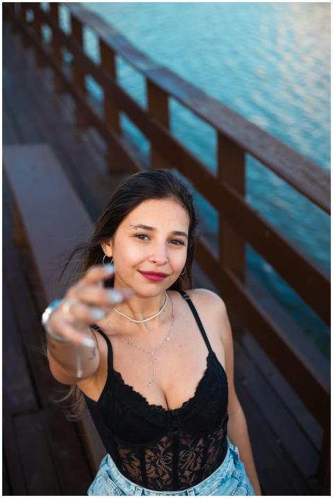 Smiling young woman in casual attire capturing a s