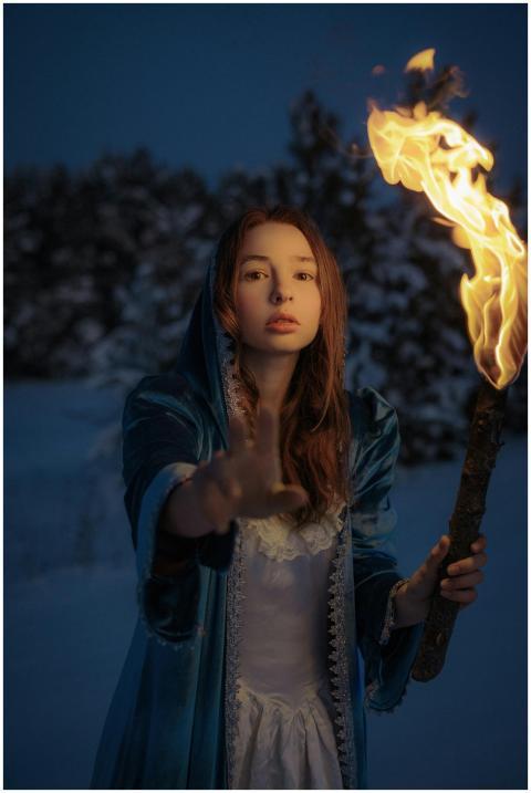 A captivating image of a woman holding a flaming t