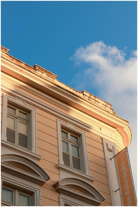 Elegant building facade with blue sky and clouds i