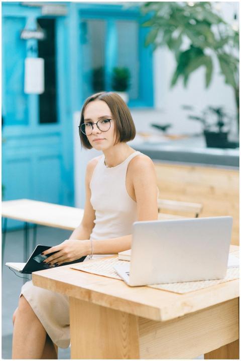 Woman sitting at a wooden desk in a stylish indoor