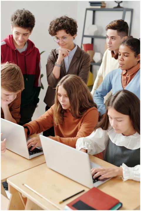 Group of teenagers in a classroom collaboratively