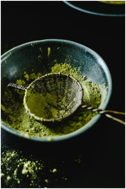 Close-up of matcha powder in a ceramic bowl with a
