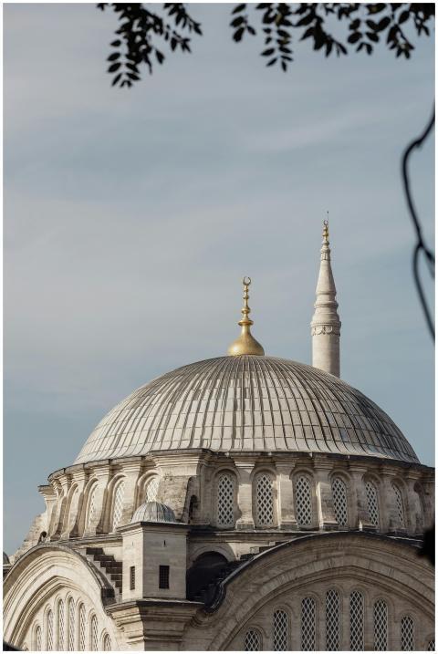 A stunning view of a mosque dome with a golden cre