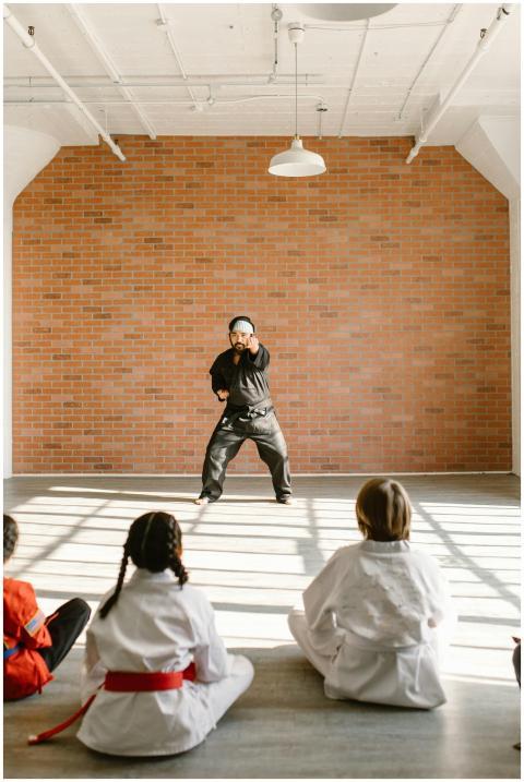 Karate instructor demonstrates techniques to atten