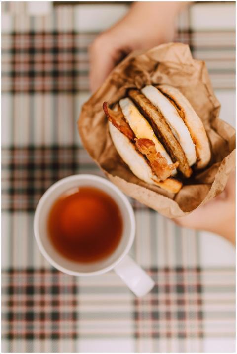 Close-up of a breakfast sandwich with bacon, egg,