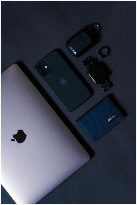 Flat lay of tech gadgets including a smartphone, l