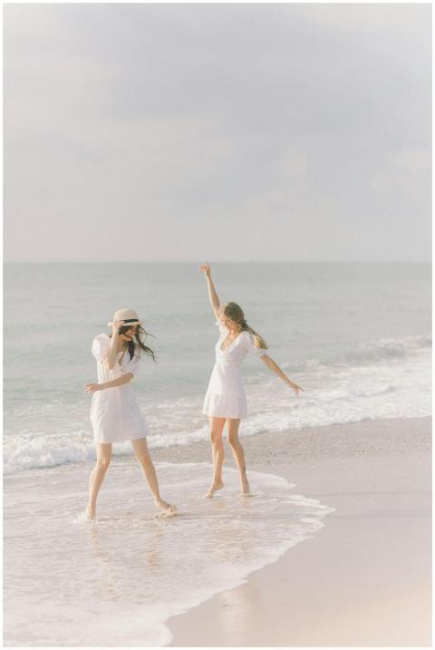 Two women in white dresses enjoying a carefree mom