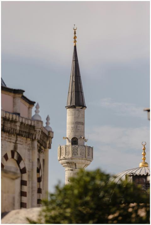 A detailed view of a minaret in Istanbul under a c