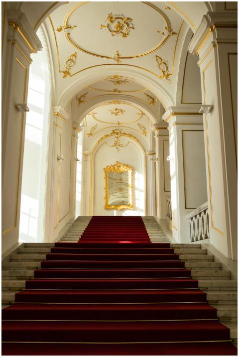 Majestic staircase with red carpet in a historic b
