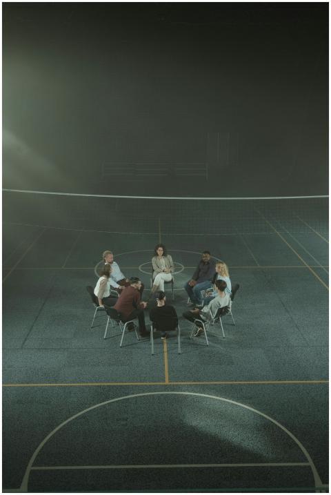 Multicultural support group sitting in a circle in
