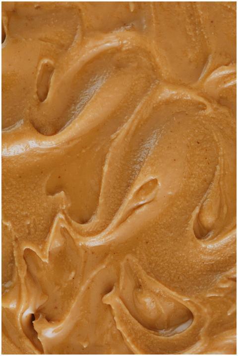 A detailed close-up of creamy peanut butter swirls