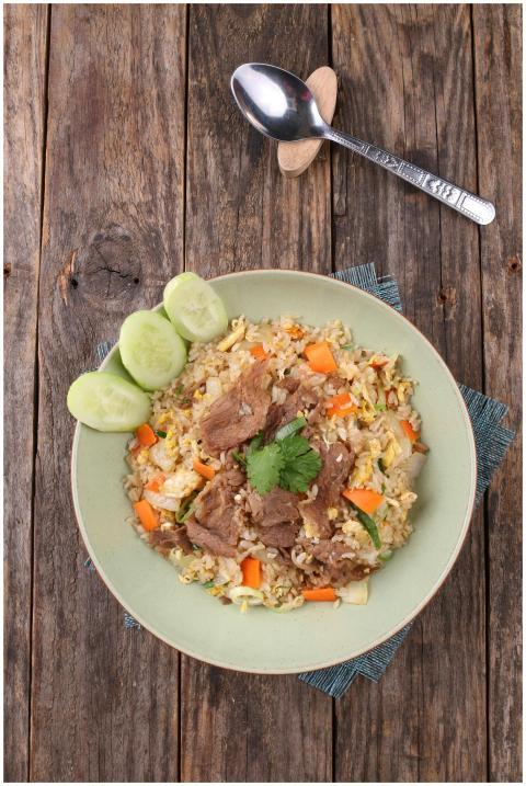 Top view of a flavorful pork fried rice dish on ru