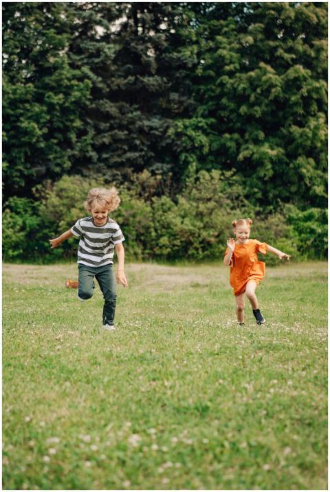 Two happy children joyfully running on a sunny day